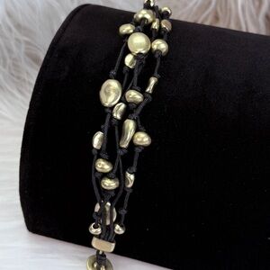Beautiful, black and goldtone accent multi strand costume bracelet